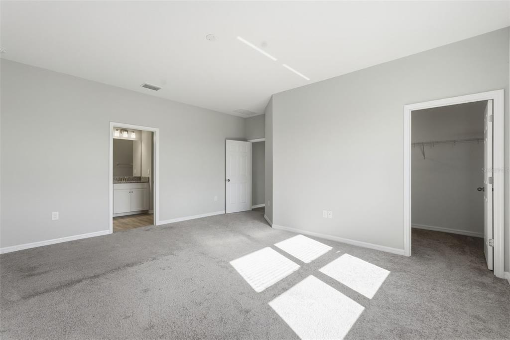 17618 Cortes Creek Boulevard Spring Hill, FL 34610 - Photo 23 of 40 a view of an empty room with wooden floor and a window