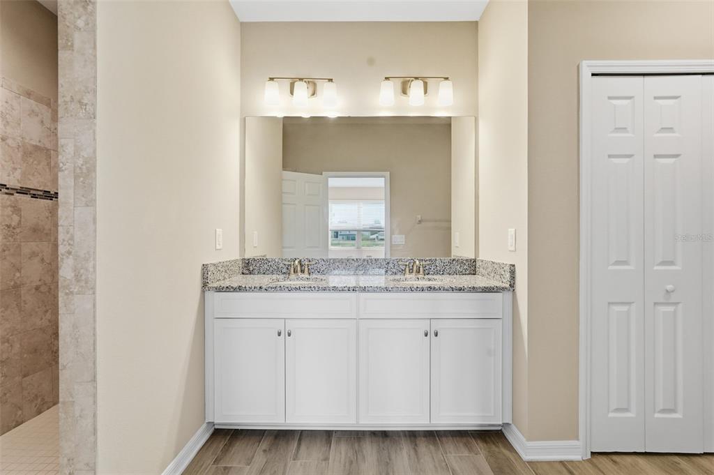 17618 Cortes Creek Boulevard Spring Hill, FL 34610 - Photo 24 of 40 a bathroom with a granite countertop sink and a mirror