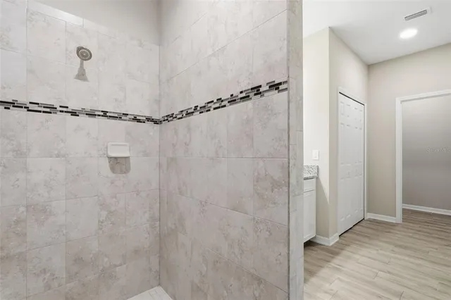 a bathroom with a glass shower door