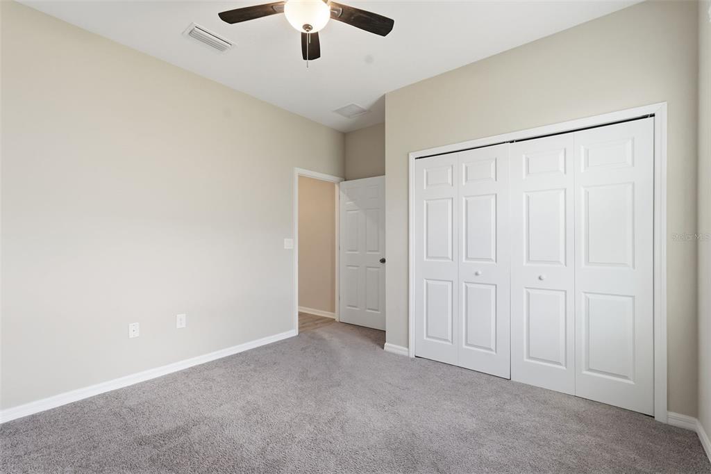 17618 Cortes Creek Boulevard Spring Hill, FL 34610 - Photo 28 of 40 an empty room with chandelier fan