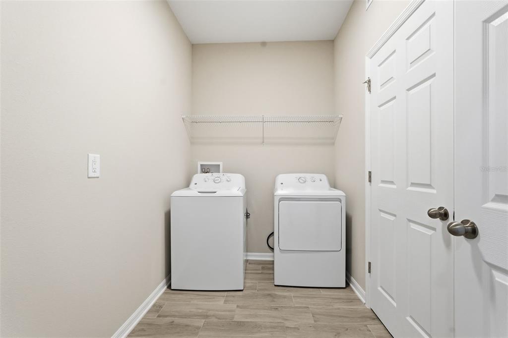 17618 Cortes Creek Boulevard Spring Hill, FL 34610 - Photo 30 of 40 a utility room with dryer and washer