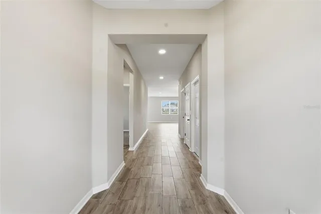a view of a hallway with wooden floor