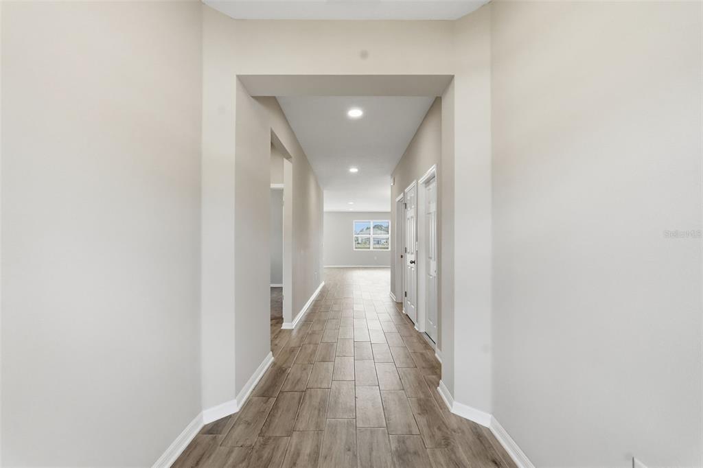 17618 Cortes Creek Boulevard Spring Hill, FL 34610 - Photo 3 of 40 a view of a hallway with wooden floor