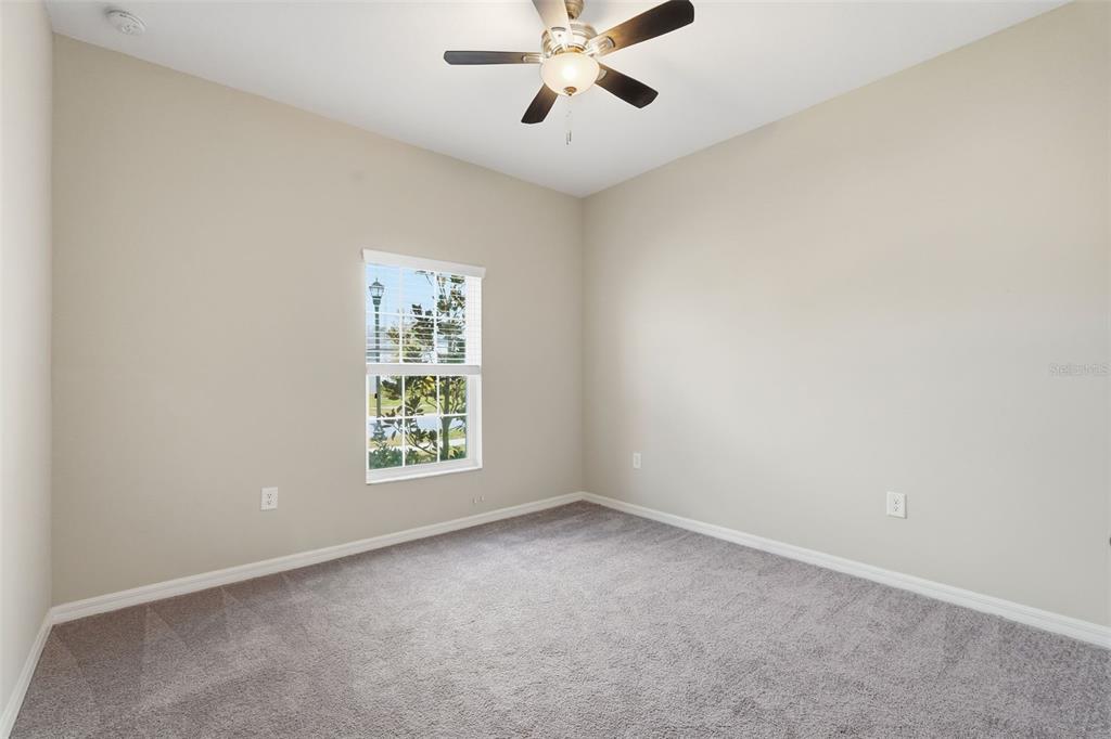 17618 Cortes Creek Boulevard Spring Hill, FL 34610 - Photo 4 of 40 an empty room with windows and ceiling fan