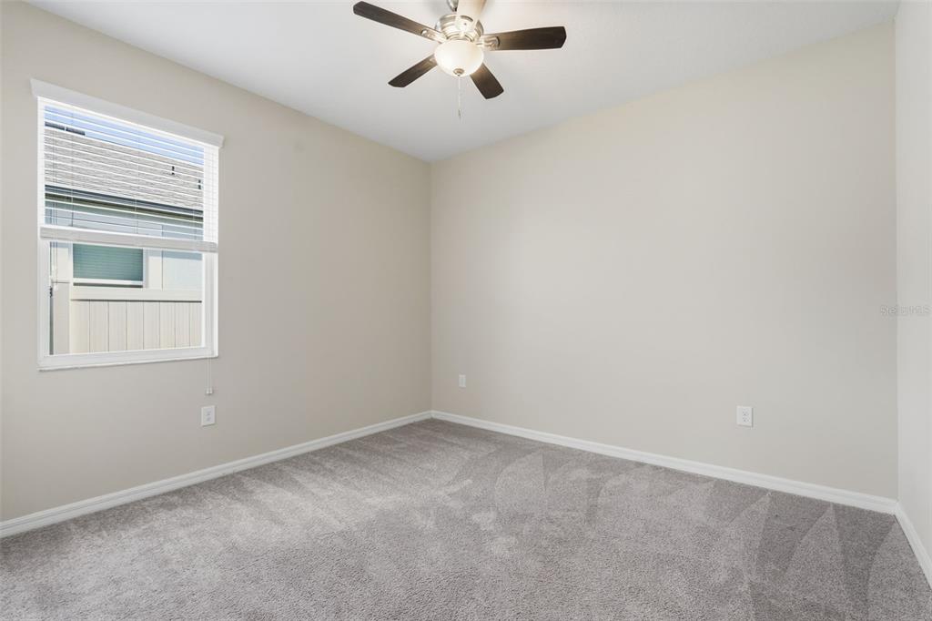 17618 Cortes Creek Boulevard Spring Hill, FL 34610 - Photo 7 of 40 an empty room with a window and a fan