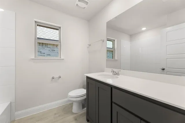 a kitchen with stainless steel appliances granite countertop a sink a stove and refrigerator