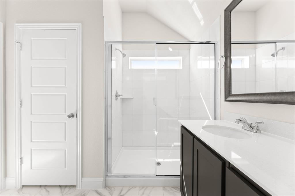 1007 Sedona Trail Justin, TX 76247 - Photo 21 of 40 a bathroom with a shower sink and mirror