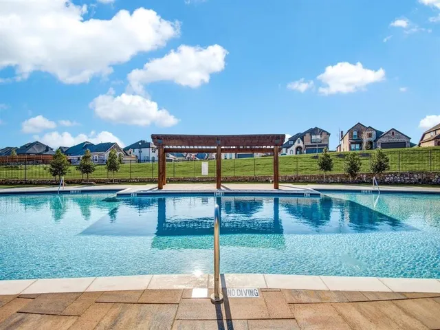 a view of house with swimming pool outdoor seating