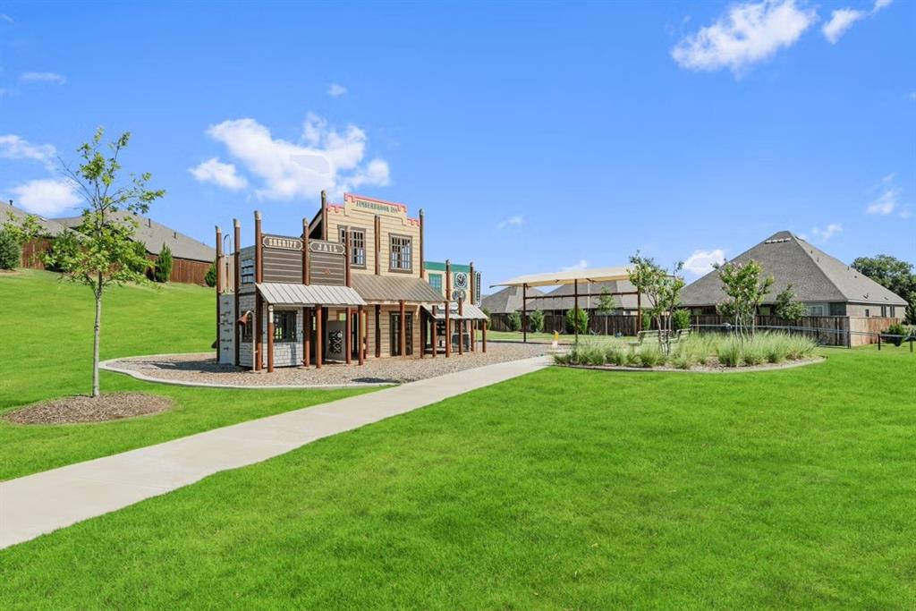 1007 Sedona Trail Justin, TX 76247 - Photo 36 of 40 a view of a house with a yard and table and chairs