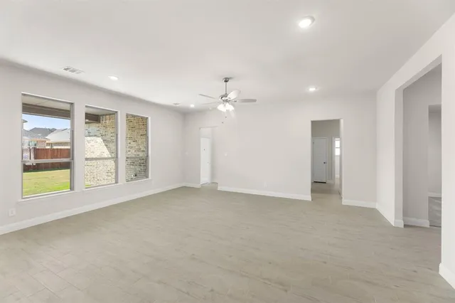 an empty room with windows and closet