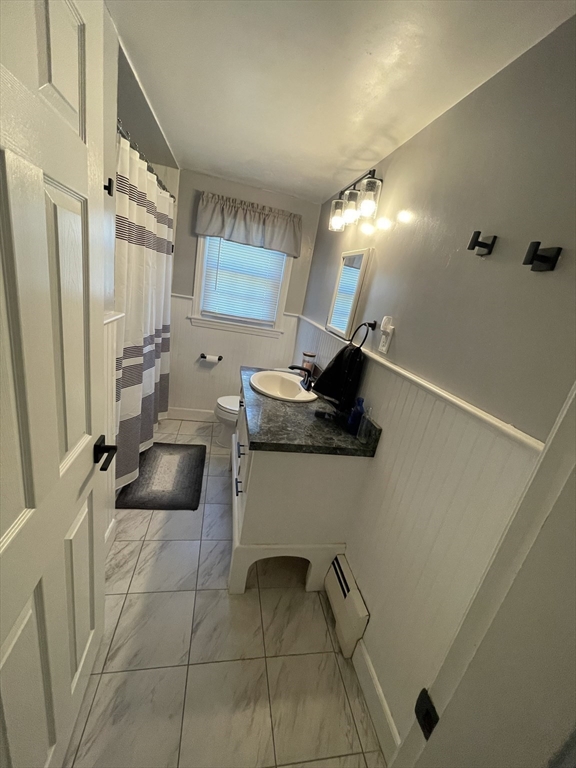 109 Oak Street Raynham, MA 02767 - Photo 7 of 9 a bathroom with a sink a toilet and mirror