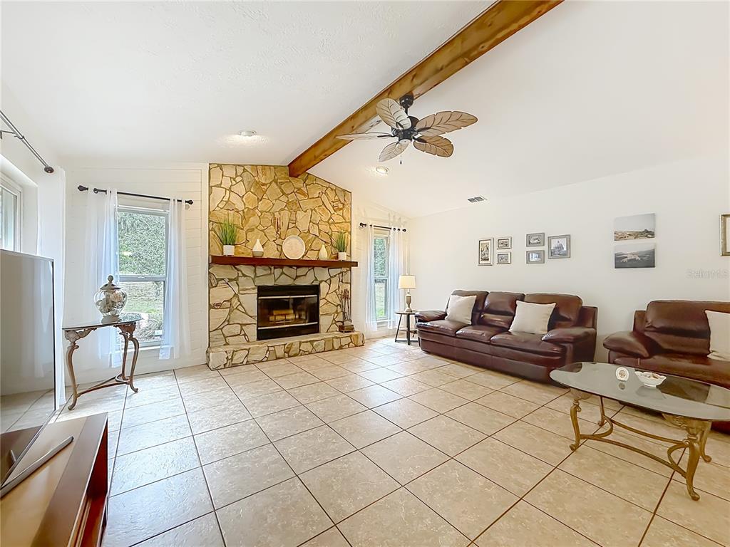 4353 North Indianhead Road Hernando, FL 34442 - Photo 13 of 65 a living room with furniture and a fireplace