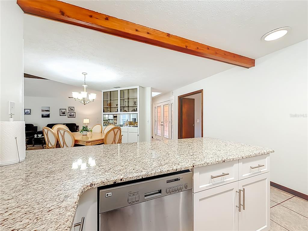 4353 North Indianhead Road Hernando, FL 34442 - Photo 21 of 65 a very nice looking kitchen with granite countertop a sink white cabinets and a wooden floor