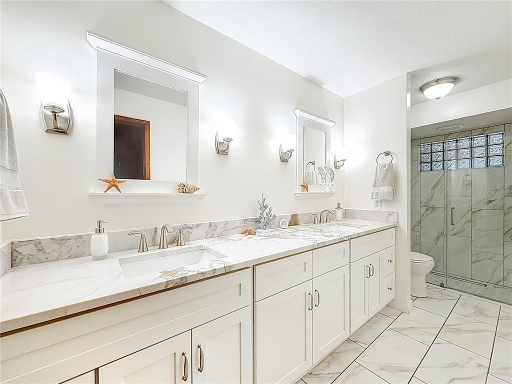 4353 North Indianhead Road Hernando, FL 34442 - Photo 25 of 65 a bathroom with a double vanity sink mirror double shower and a bathtub