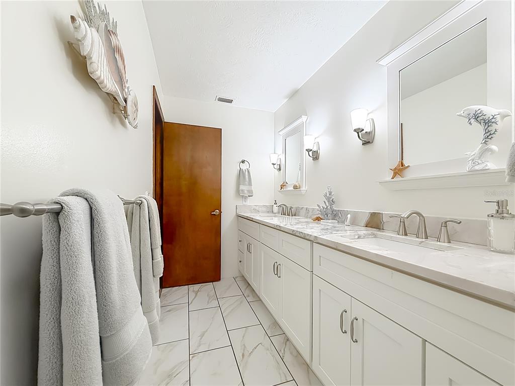4353 North Indianhead Road Hernando, FL 34442 - Photo 26 of 65 a bathroom with a double vanity sink and mirror