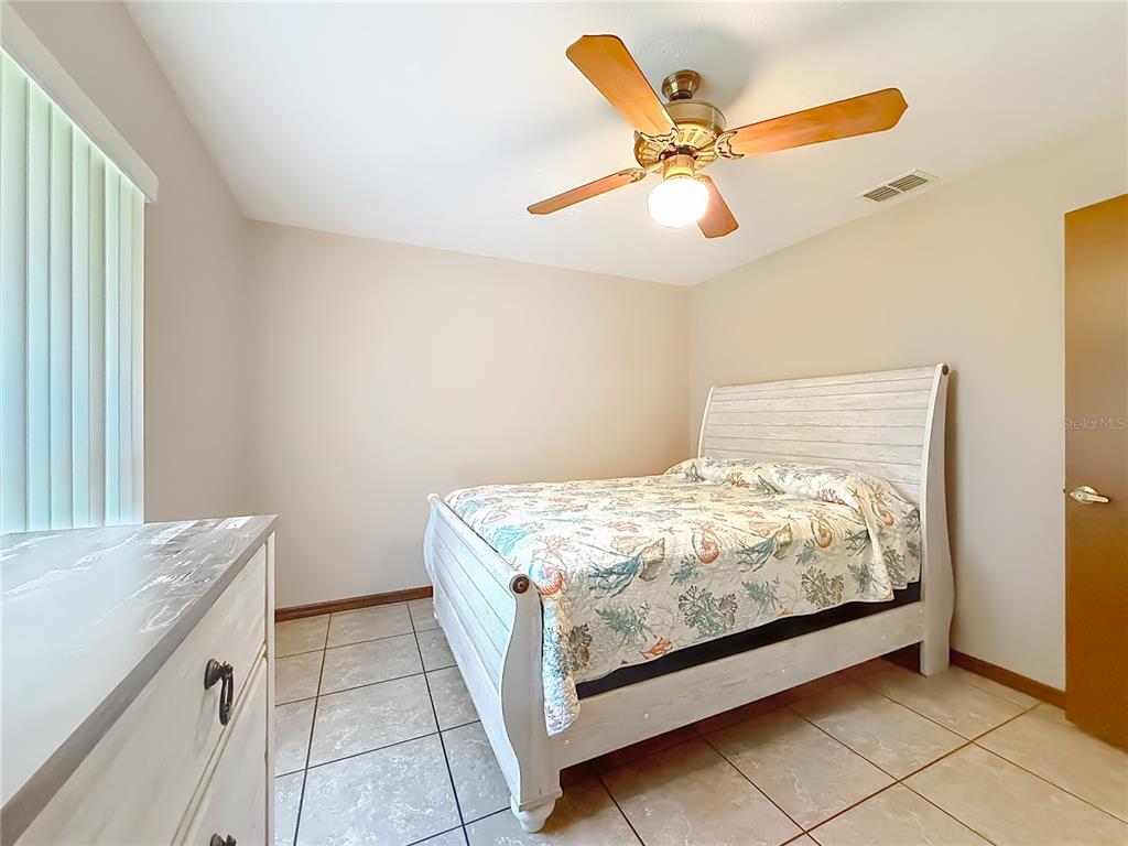 4353 North Indianhead Road Hernando, FL 34442 - Photo 31 of 65 a bedroom with a bed and a ceiling fan