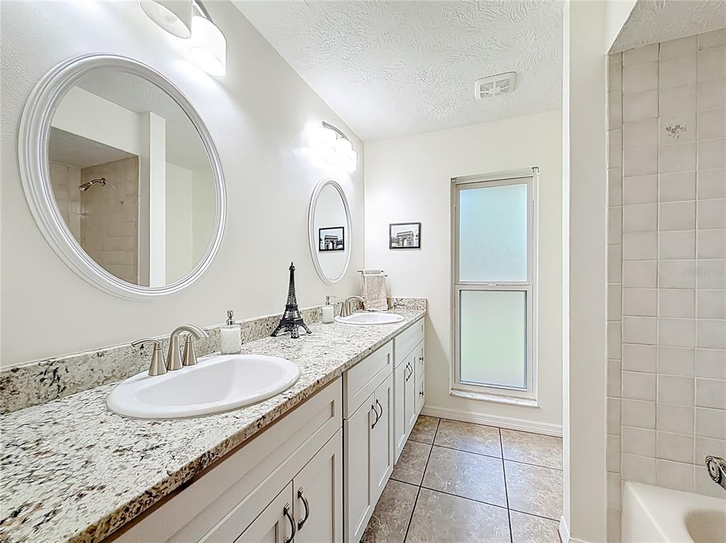 4353 North Indianhead Road Hernando, FL 34442 - Photo 33 of 65 a bathroom with a granite countertop sink and a mirror