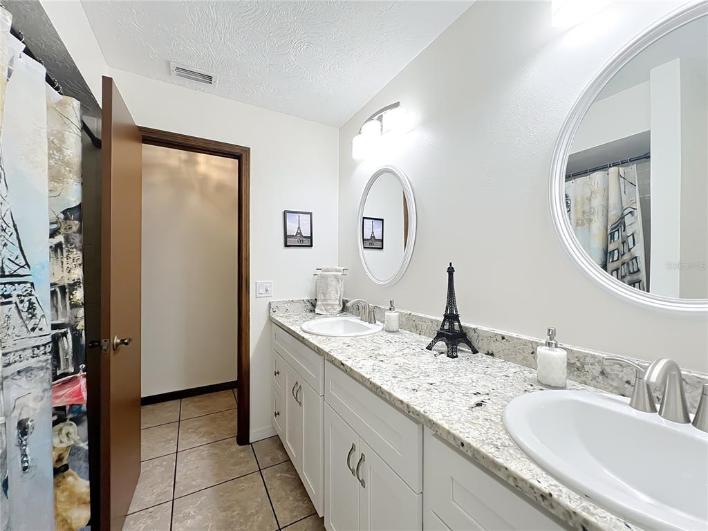 4353 North Indianhead Road Hernando, FL 34442 - Photo 35 of 65 a bathroom with a double vanity sink and a mirror