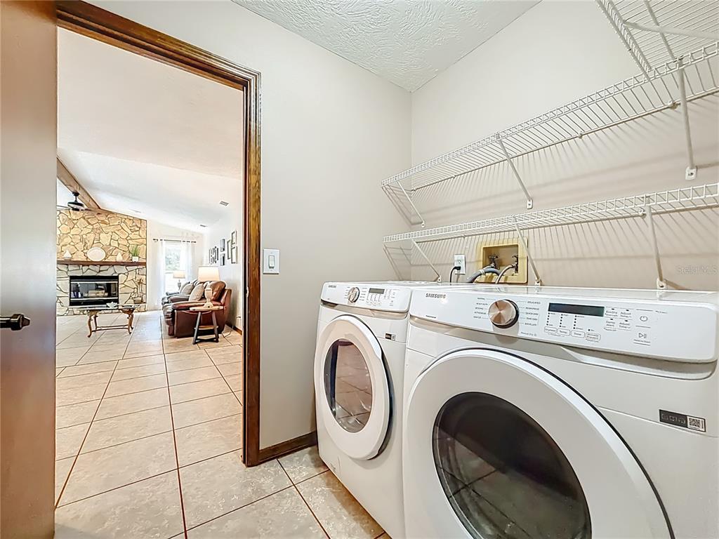 4353 North Indianhead Road Hernando, FL 34442 - Photo 40 of 65 a view of washer and dryer with kitchen in the background