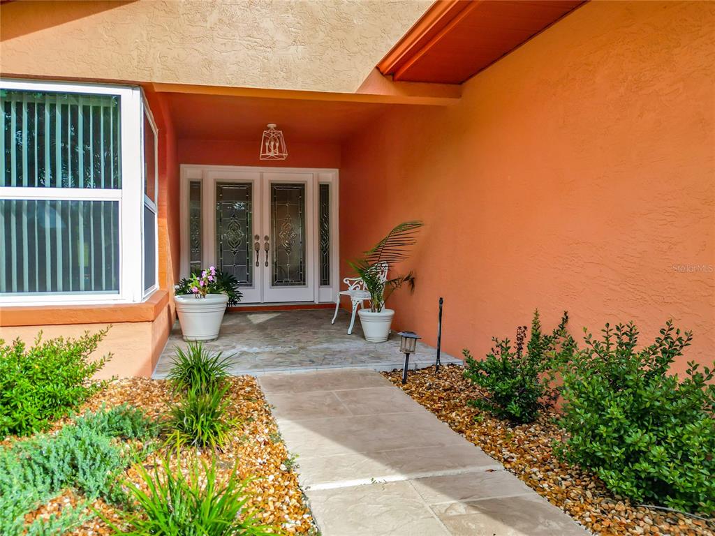 4353 North Indianhead Road Hernando, FL 34442 - Photo 50 of 65 a view of a house with backyard sitting area and garden