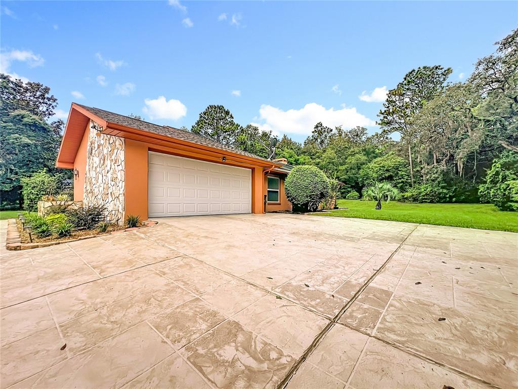 4353 North Indianhead Road Hernando, FL 34442 - Photo 52 of 65 a front view of a house with a yard and a garage