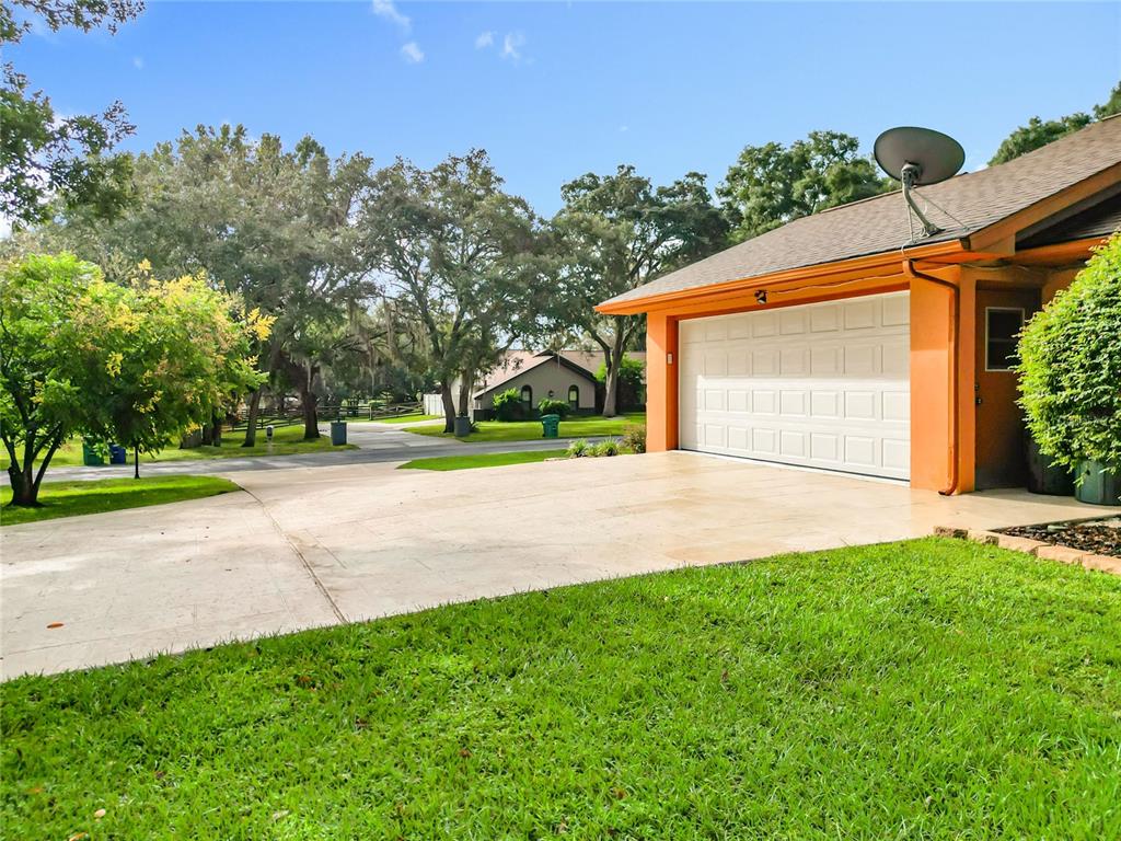 4353 North Indianhead Road Hernando, FL 34442 - Photo 53 of 65 a front view of a house with a yard and garage