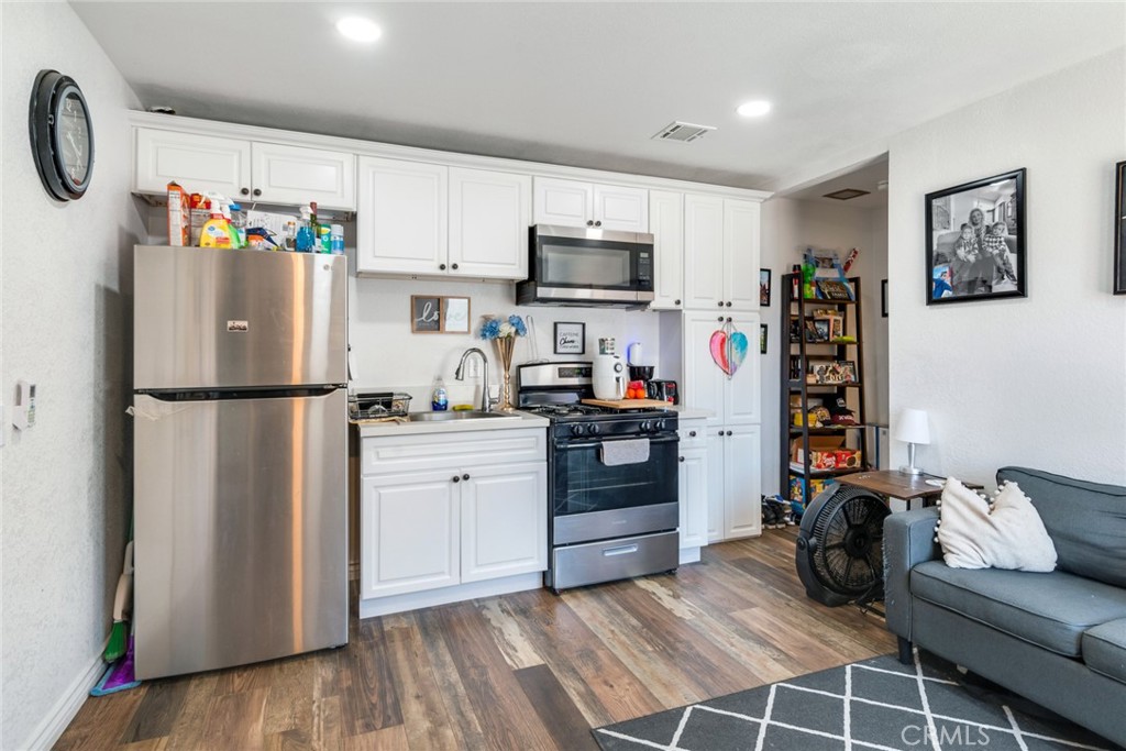 2767 Attenborough Place Riverside, CA 92503 - Photo 23 of 39 a kitchen with stainless steel appliances a refrigerator sink and cabinets