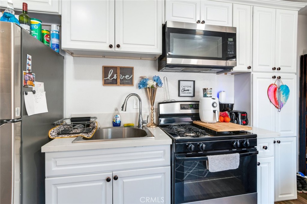 2767 Attenborough Place Riverside, CA 92503 - Photo 24 of 39 a kitchen with stainless steel appliances granite countertop a stove and a microwave