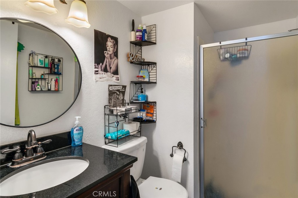 2767 Attenborough Place Riverside, CA 92503 - Photo 25 of 39 a bathroom with a sink toilet and a mirror