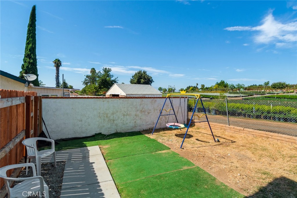 2767 Attenborough Place Riverside, CA 92503 - Photo 27 of 39 a view of a swimming pool with a patio and a yard