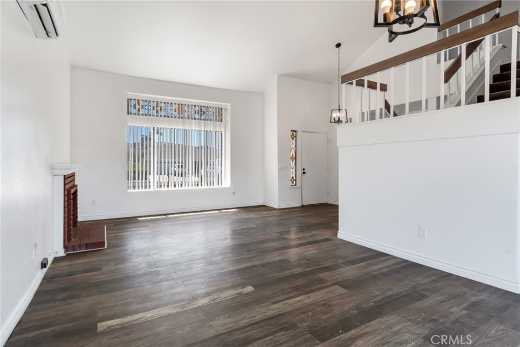 2767 Attenborough Place Riverside, CA 92503 - Photo 6 of 39 a view of an empty room with wooden floor and a window
