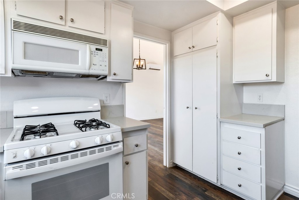 2767 Attenborough Place Riverside, CA 92503 - Photo 9 of 39 a kitchen with stainless steel appliances white cabinets and stove