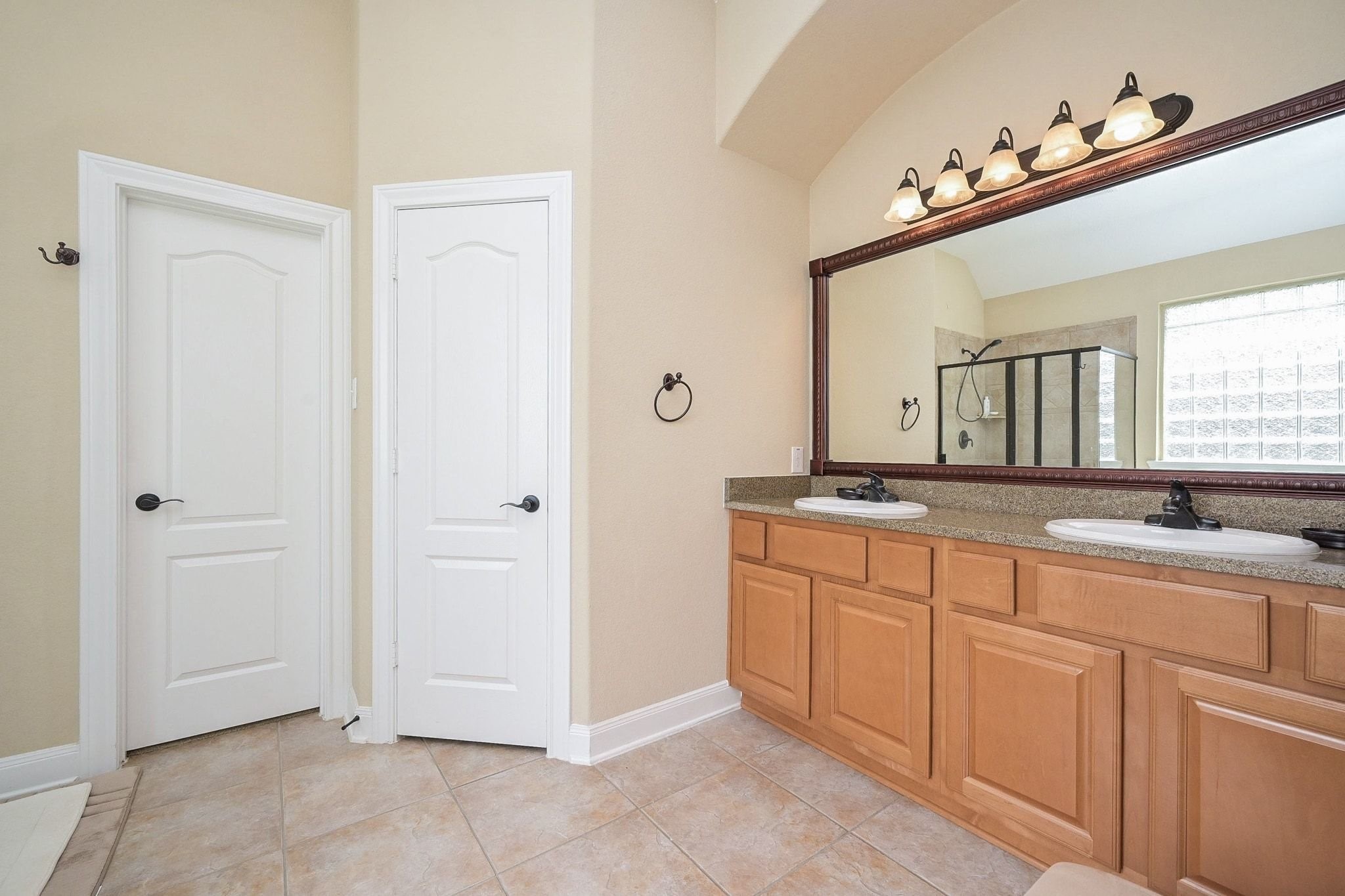 107 North Bacopa Drive Spring, TX 77389 - Photo 24 of 34 Double vanity with ample counter space and storage, paired with a large mirror that enhances light throughout the space.