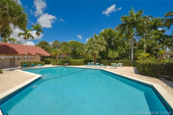 a view of swimming pool is middle in the garden