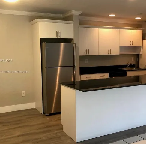 a kitchen with stainless steel appliances a refrigerator and a stove