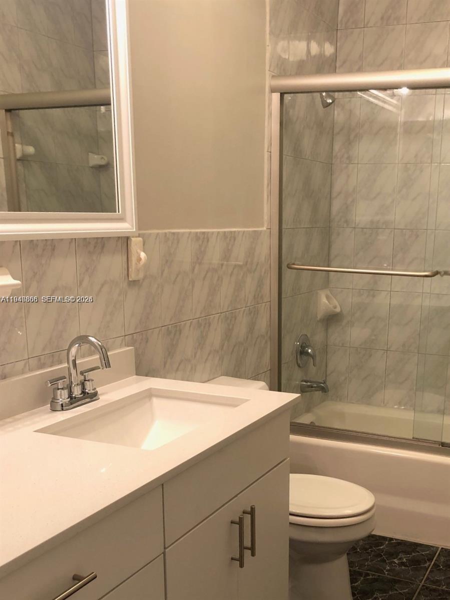 9350 Southwest 77th Avenue, Unit G8 Miami, FL 33156 - Photo 6 of 11 a bathroom with a sink and a mirror