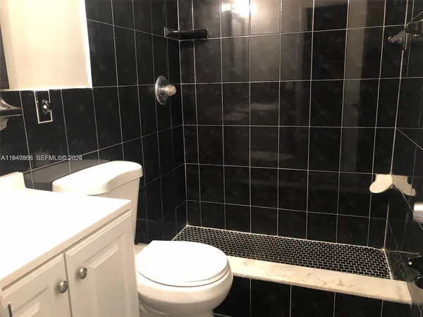a bathroom with a black white checkered floor