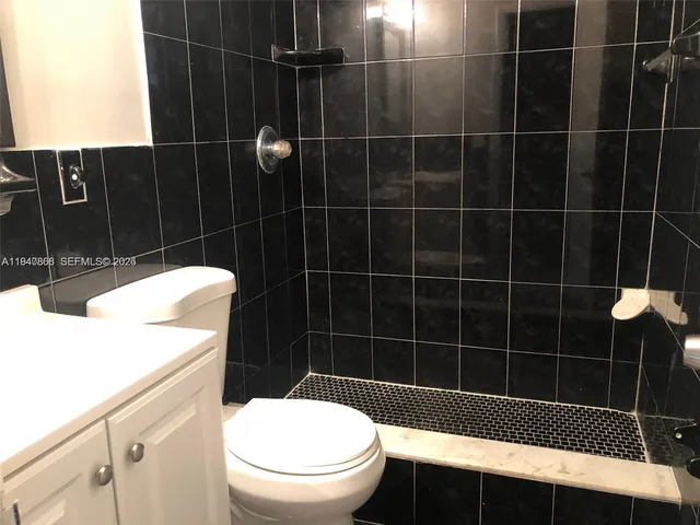 a bathroom with a black white checkered floor