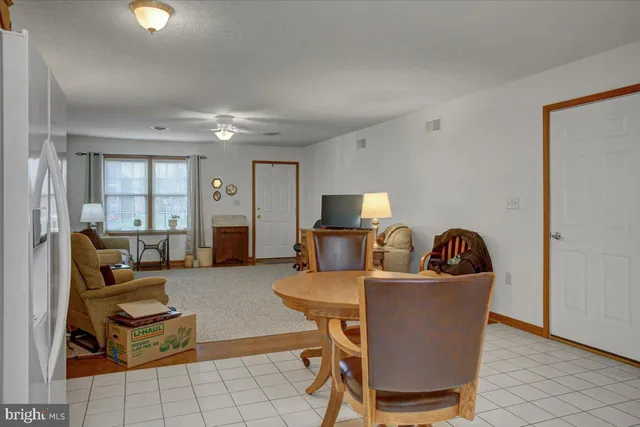 a living room with furniture a flat screen tv and a window