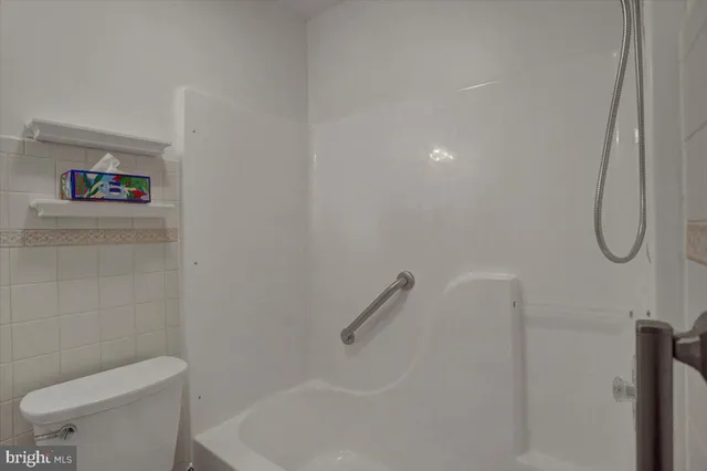a bathroom with a toilet and a shower