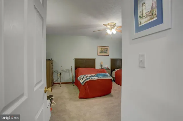 a bedroom with a bed and a lamp on the dresser