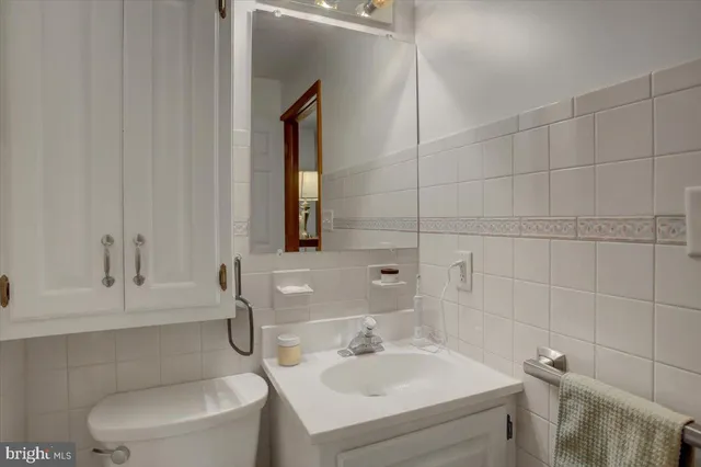 a bathroom with a sink a toilet and mirror