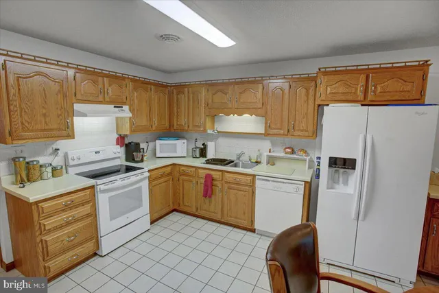 a kitchen with a refrigerator stove and sink