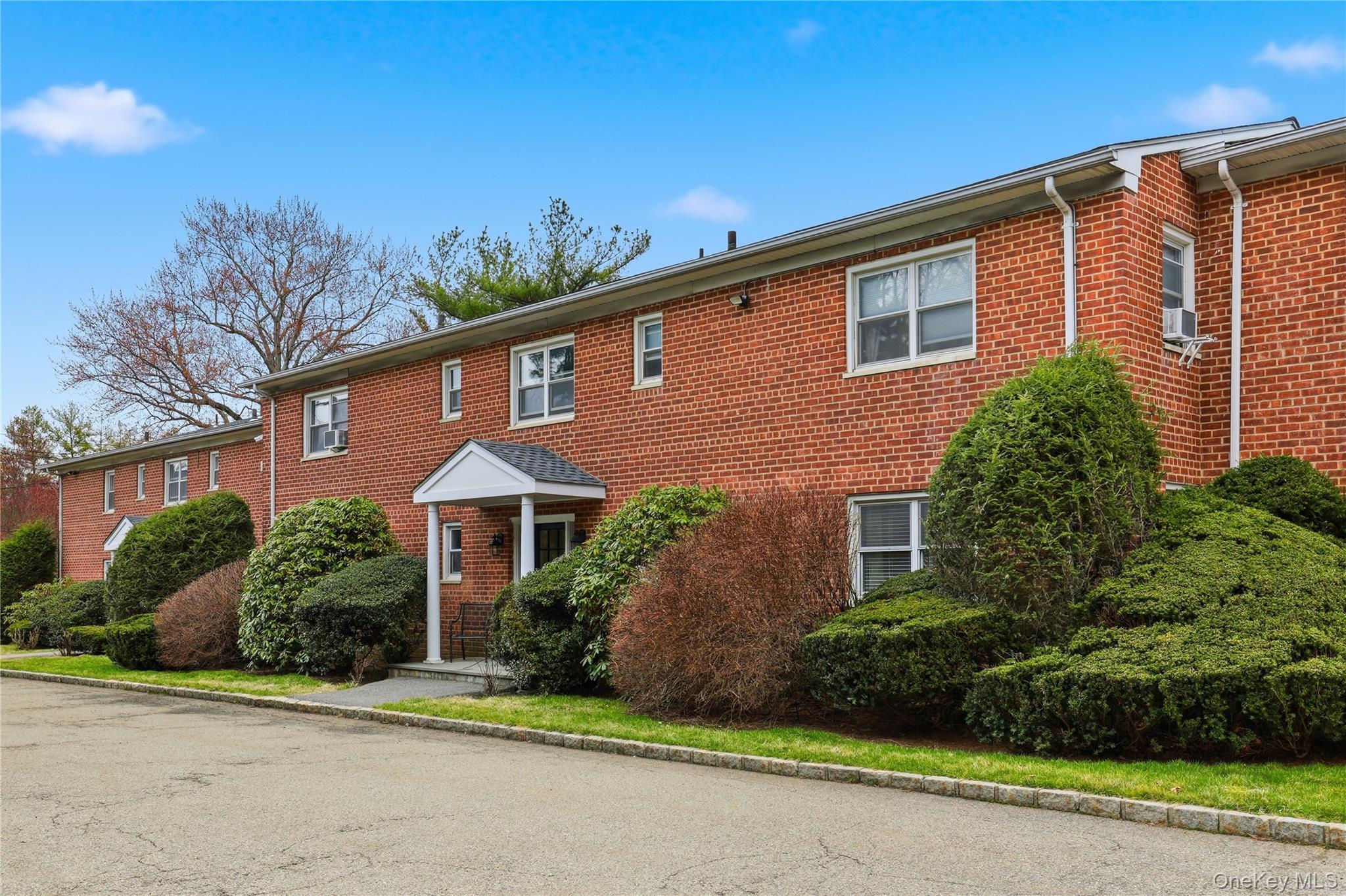 352 North State Road, Unit 1H Briarcliff Manor, NY 10510 - Photo 19 of 20 front view of a house with a yard