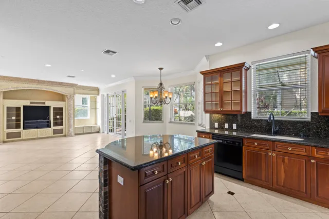 an empty room with windows and ceiling fan