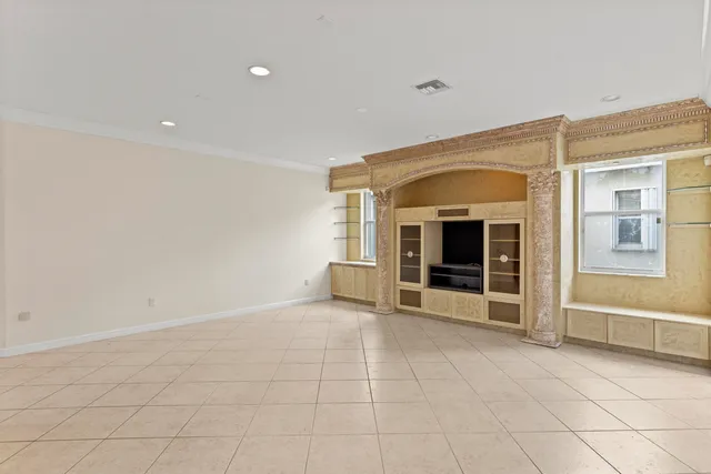 an empty room with a ceiling fan and a window