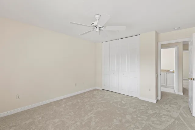 a kitchen with granite countertop white cabinets and sink