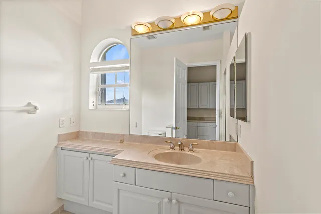 a sign that is sitting on the grass next to a road