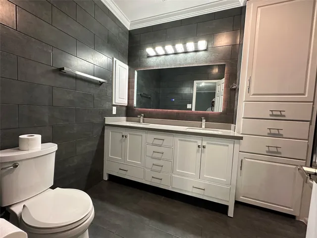 a bathroom with a sink vanity tub and a mirror