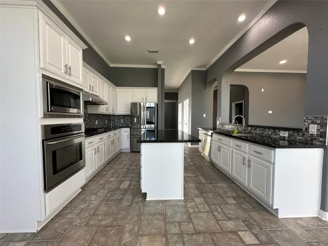 a large kitchen with stainless steel appliances